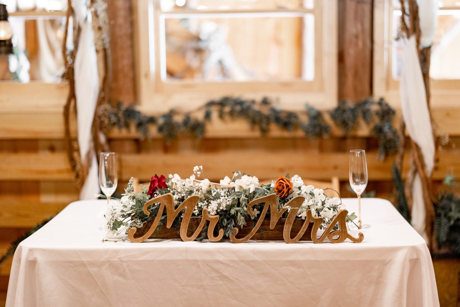 Head table with wooden Mr and Mrs sign at the Honeysucke Hills cottage garden wedding venue