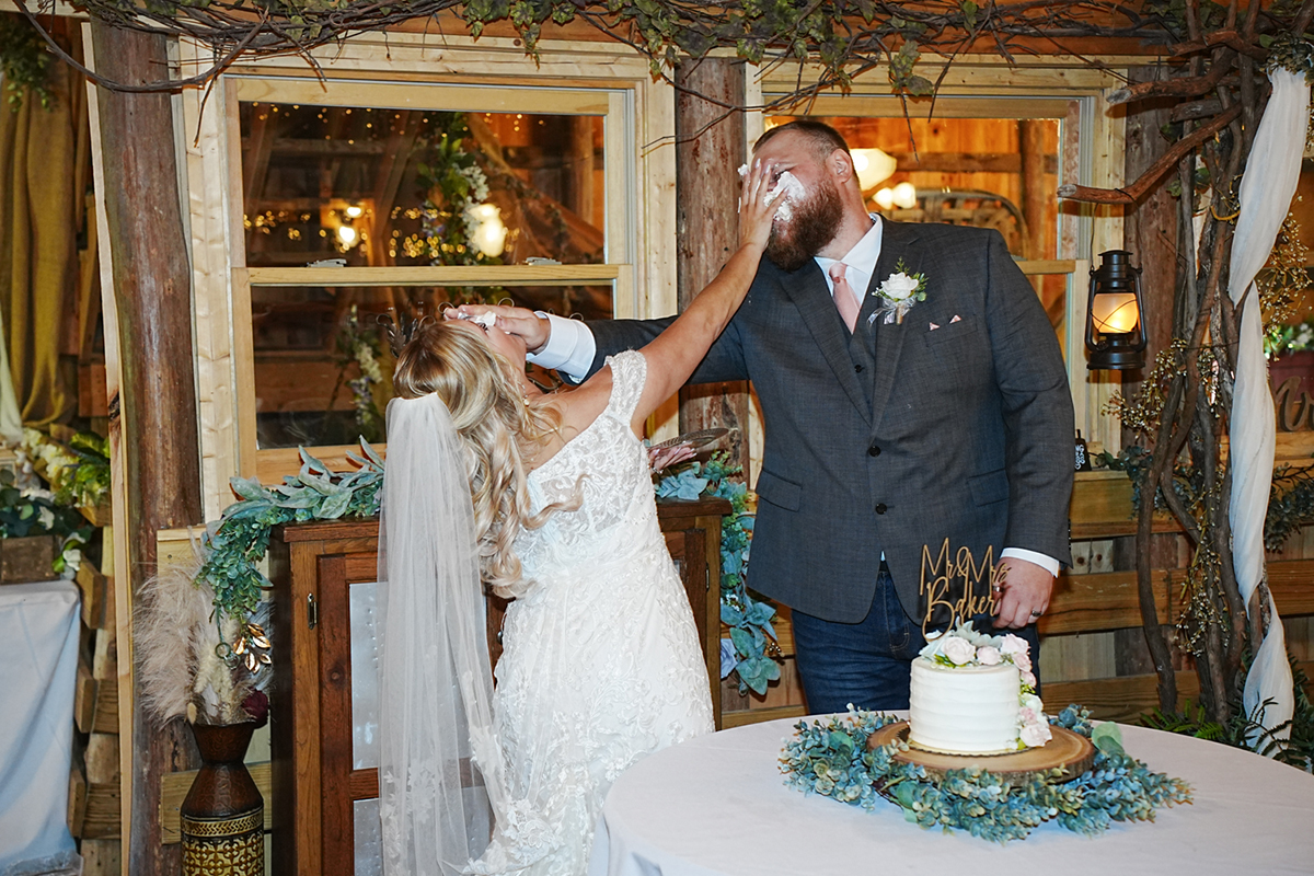 fun cake smash at the head table of a wedding reception at Honeysuckle Hills in Pigeon Forge