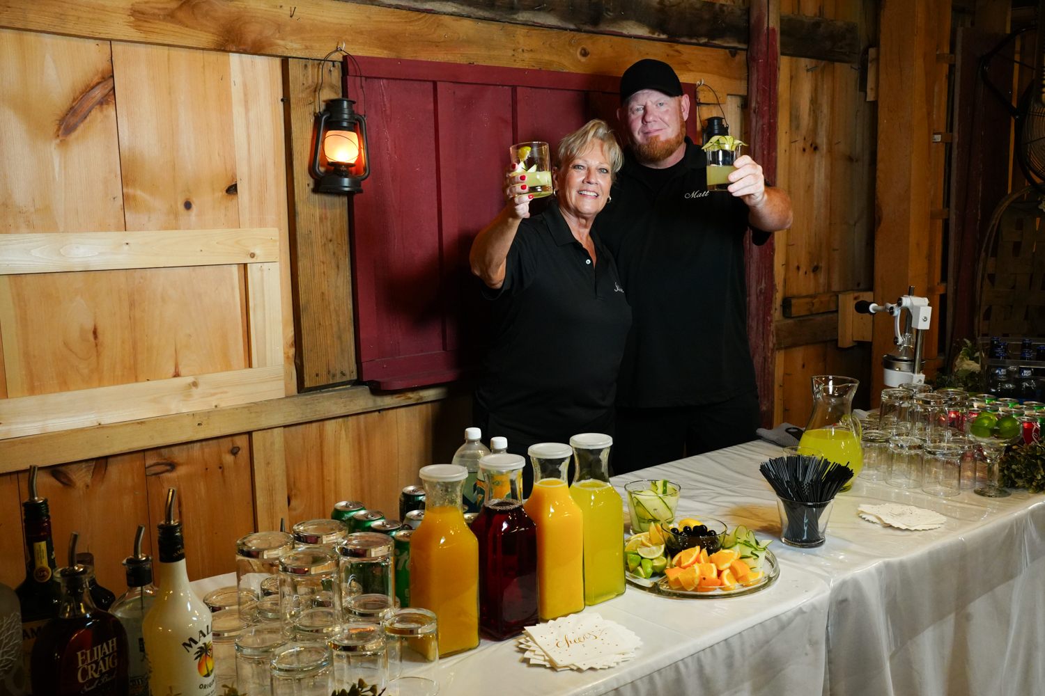 Bartender Julie with her son Matt posing for a photo at the bar for a reception at the Honeysuckle Hills wedding venue