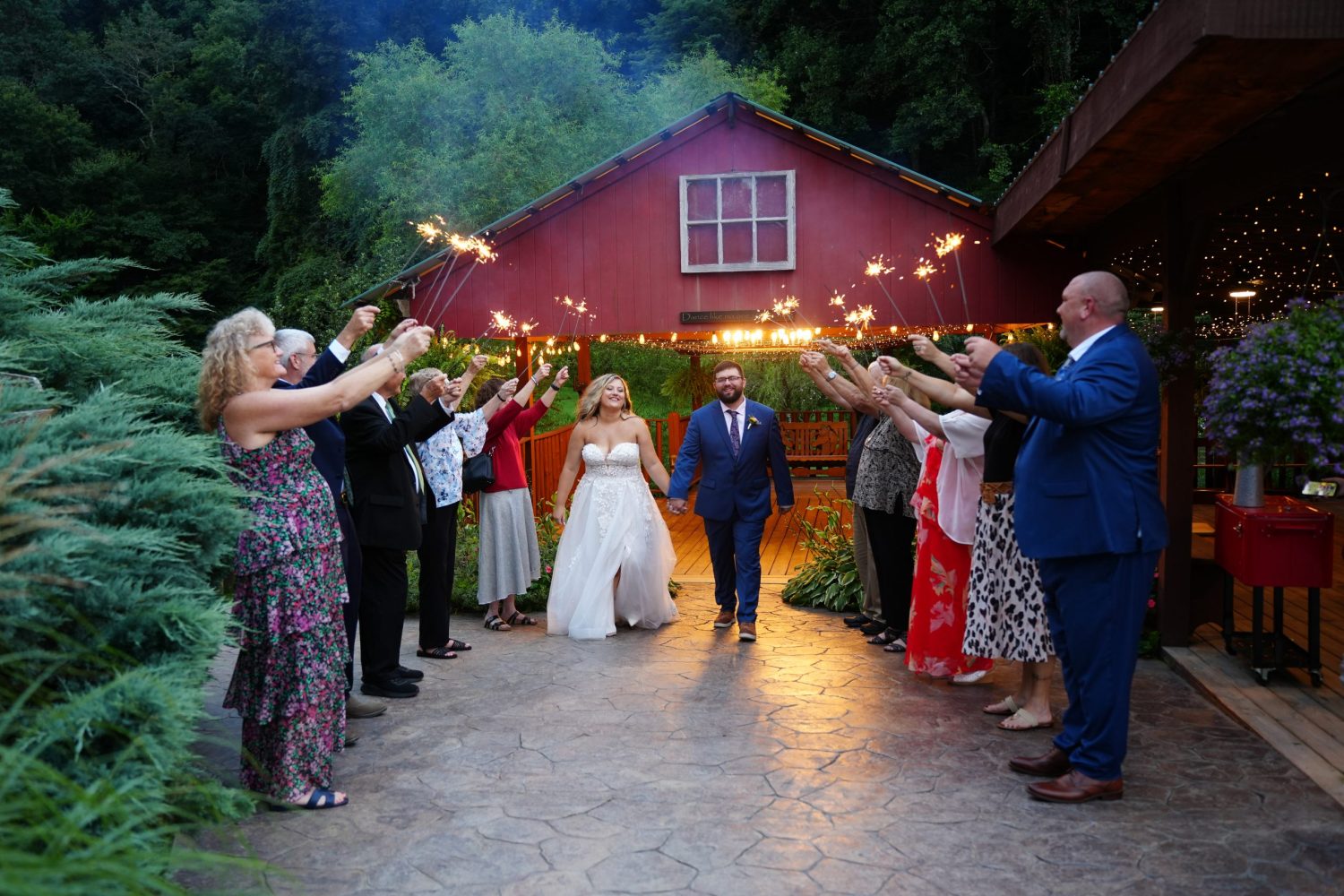 sparkler exit in front of the red creekside pavilion at Honeysuckle Hills in the Smoky Mountains