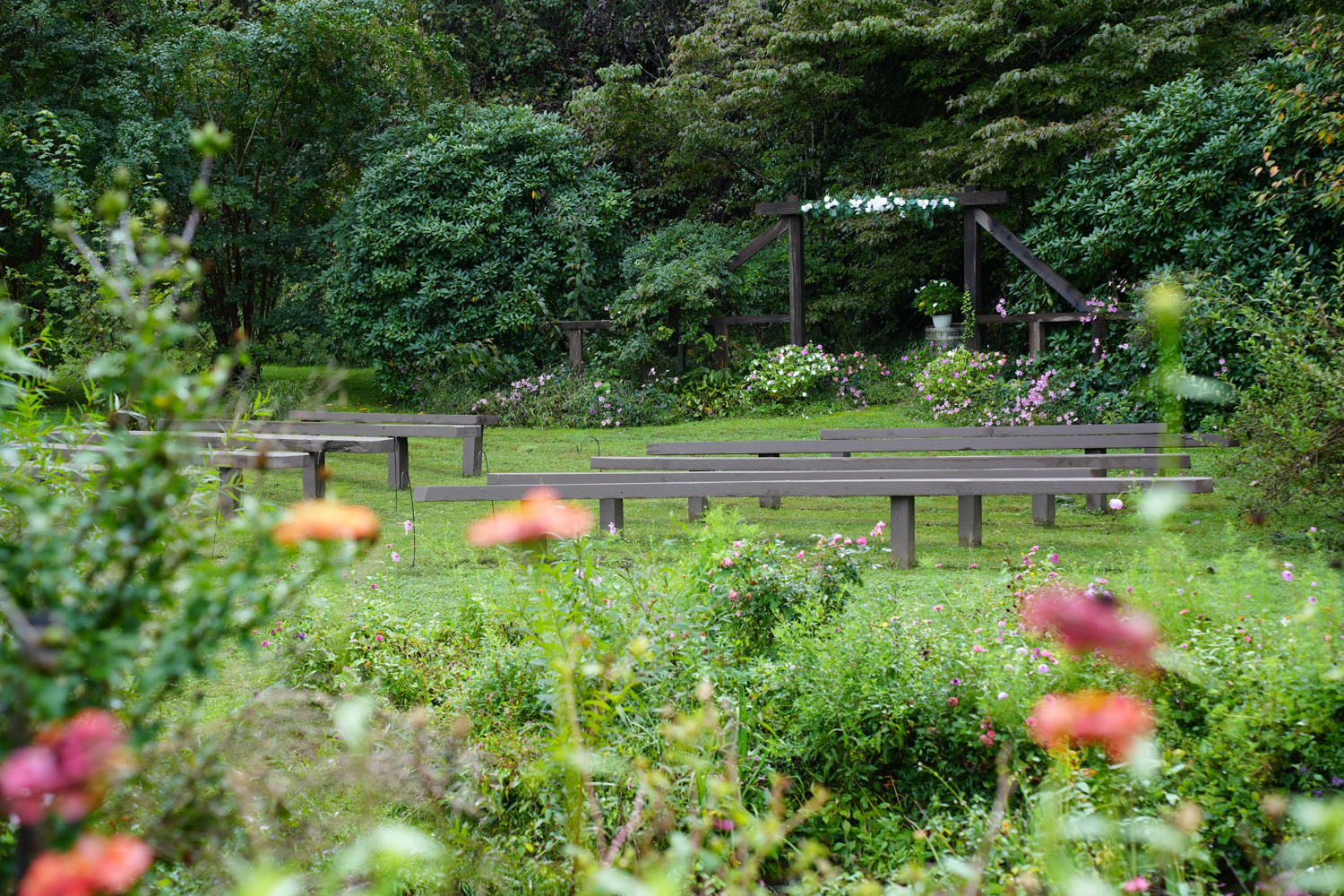 Sumemr wedding gardens at the wooden arbor called Creekside Ridge at Honeysuckle Hills in the Smoky Mountains